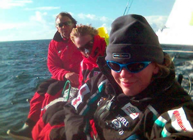 Sophie Luther, Johan Wigforss and Håkan Prising sitting on the rail of Avant at the Round Gotland Race.